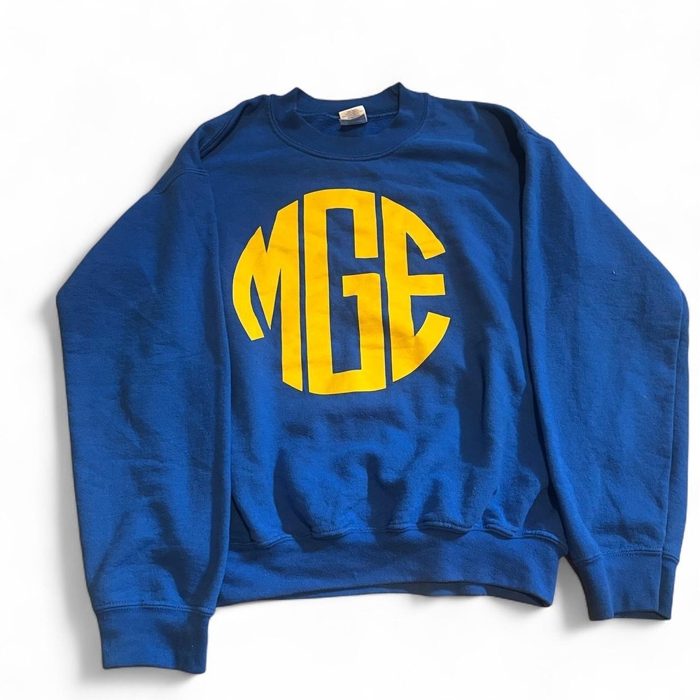 Blue crewneck sweatshirt with yellow monogram in a circle, size S